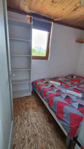 a small bedroom with a bed and a window at Pool place in Petrovče