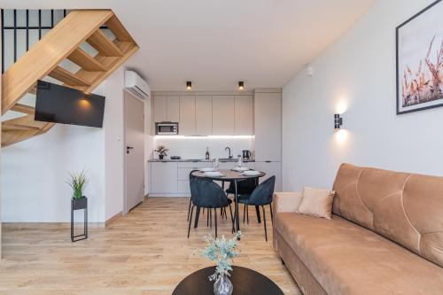 a living room with a couch and a table at Morska Oaza Jantar in Jantar