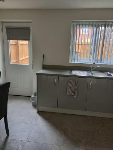 a kitchen with a sink and a counter top at Mesnes Place in Wigan