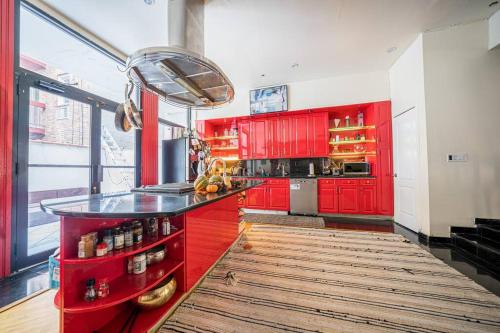 a kitchen with red cabinets and a counter top at Private Gramercy TownHouse 3BR 3BA with Terrace in New York