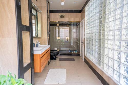 a bathroom with a sink and a toilet and a mirror at Private Gramercy TownHouse 3BR 3BA with Terrace in New York