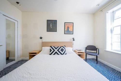 a bedroom with a large white bed and a chair at Private Gramercy TownHouse 3BR 3BA with Terrace in New York
