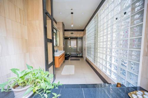 a hallway of a bathroom with a sink and a mirror at Private Gramercy TownHouse 3BR 3BA with Terrace in New York