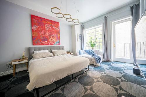 a bedroom with a large bed in a room with windows at Private Gramercy TownHouse 3BR 3BA with Terrace in New York