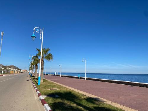una luz de la calle en una acera junto al océano en Seabreeze House, en Oued Laou