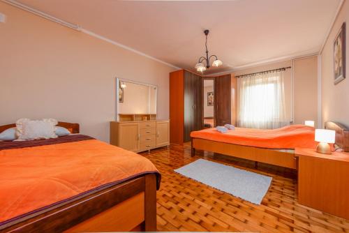 a bedroom with two beds and a dresser at Haus Rose in Gornji Prozor