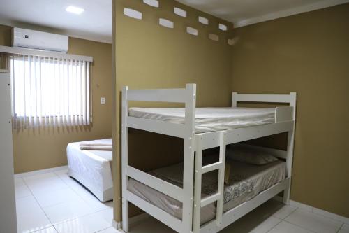 Ένα ή περισσότερα κρεβάτια σε δωμάτιο στο Casa ampla e agradável com piscina e churrasqueira