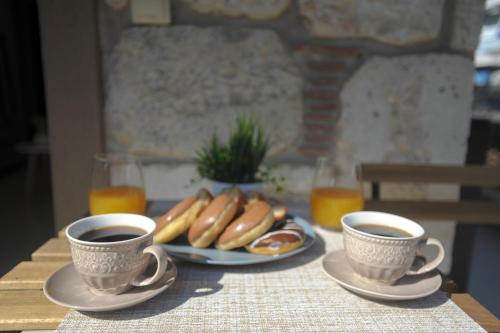 two cups of coffee and a plate of hot dogs and eggs at COZY GOLD #DTerra Apartments# FREE PRIVATE PARKING!! in Thessaloniki