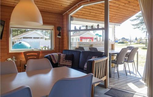 a room with chairs and tables and a patio at Cozy Home In Nexø With Wifi in Neksø