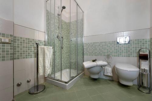 a bathroom with a shower and a toilet and a sink at Rifugio al Sole in Reggello