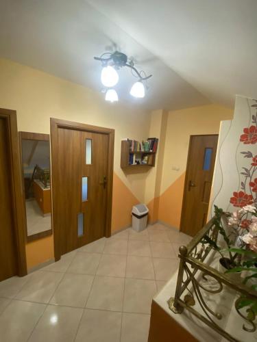 a living room with a ceiling fan and a room with a toilet at Pokoje u Eli in Solec-Zdrój