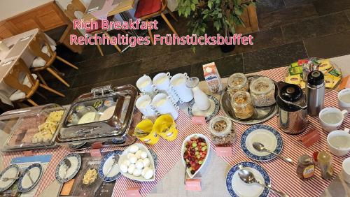 a table topped with plates and bowls of food at Hotel Schöntal in Filisur