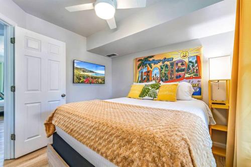 a bedroom with a large bed with yellow pillows at The Floridian, Old Florida Charm with Modern Comfort in St. George Island
