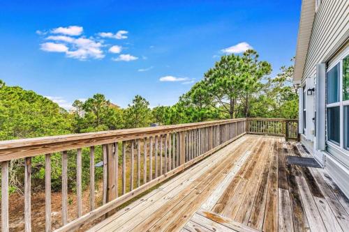 a home with a wooden deck with a fence at The Floridian, Old Florida Charm with Modern Comfort in St. George Island