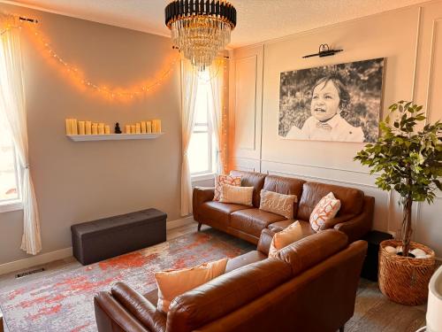 a living room with a brown leather couch at Z FamilyHome Suites & Apartments in Calgary