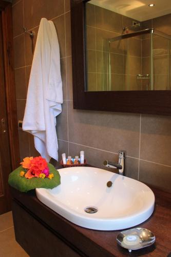 a bathroom with a sink and a mirror at Hotel Simius Playa in Villasimius