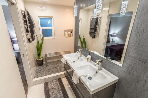 a bathroom with a sink and a mirror at Las Vegas Oasis Home Primary in Las Vegas