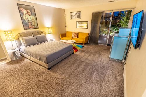 a bedroom with a bed and a couch at Las Vegas Oasis Home Primary in Las Vegas