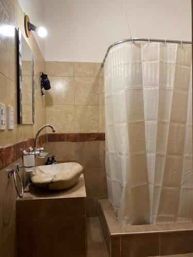 a bathroom with a sink and a shower at Complejo HUNUC in Calingasta