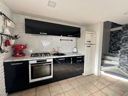 a kitchen with a sink and a stove top oven at Cozy Getaway near Palanga in Kretinga