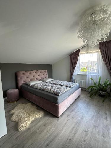 a bedroom with a large bed and a large window at Cozy Getaway near Palanga in Kretinga