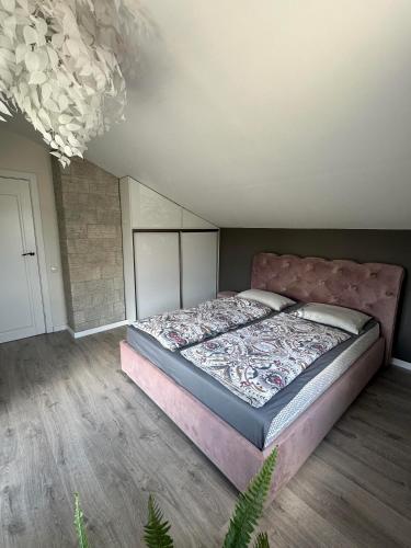 a bedroom with a large bed in a room at Cozy Getaway near Palanga in Kretinga
