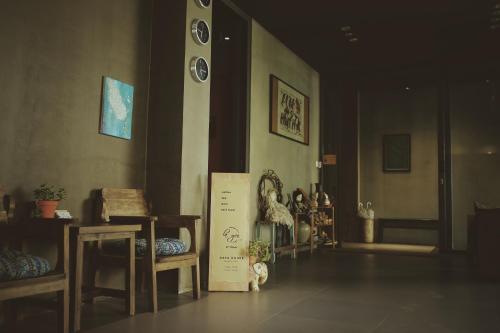 a room with chairs and a sign on the floor at La Maison Des Délices in Da Nang