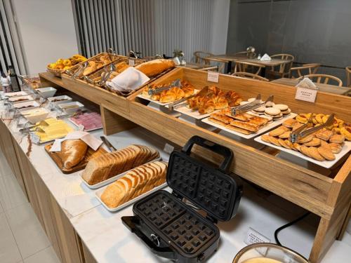 a buffet of bread and pastries on a table at HOMEFULL Apartamentos in Salta