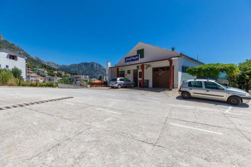 a white car parked in front of a building at Apartments by the sea Brist, Makarska - 22463 in Podaca
