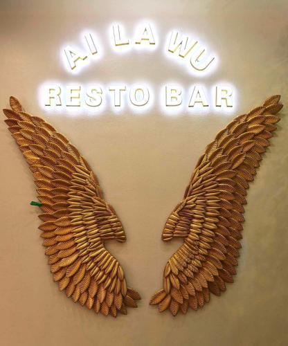 a sign with two wings on a wall at Moalboal Seaside Resort in Moalboal