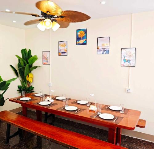 a dining room table with a ceiling fan at Moalboal Seaside Resort in Moalboal