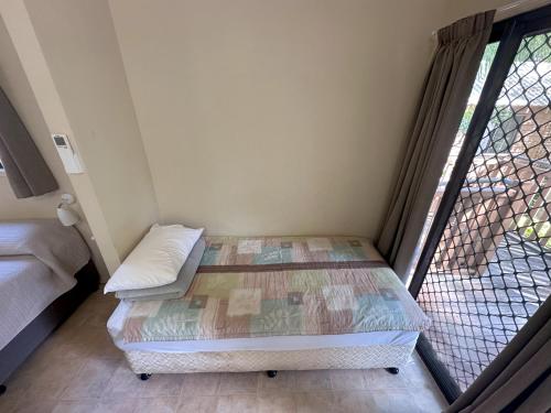 a small room with a bed and a window at 1770 Holiday Village in Seventeen Seventy