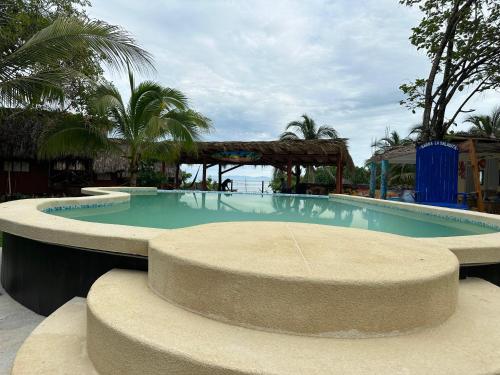 a large swimming pool in a resort at Cabaña Buganvilia Punto Surf Barra La Saladita in La Salada