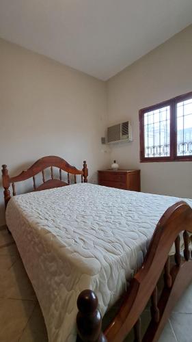 a bedroom with a large wooden bed in a room at La casa de los abuelos in Santiago del Estero
