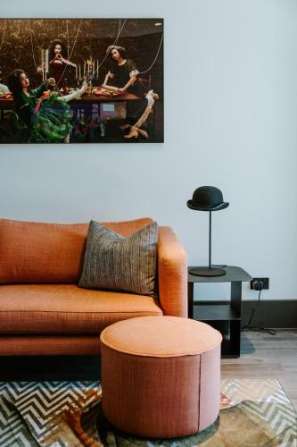 a living room with a couch and a table at The Motley Hotel Richmond, Tapestry Collection by Hilton in Melbourne