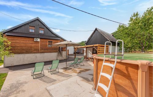 a house with a tennis court and chairs at 3 Bedroom Cozy Home In Klanac in Klanac