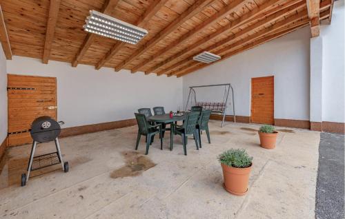 a dining room with a table and green chairs at 3 Bedroom Cozy Home In Klanac in Klanac