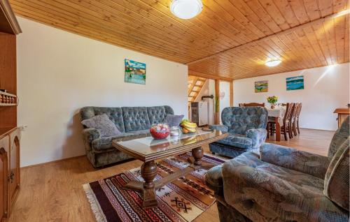 a living room with two couches and a table at 3 Bedroom Cozy Home In Klanac in Klanac