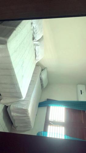 a room with a stack of white sheets and towels at Casa de praia in Cabedelo