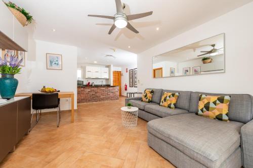 a living room with a couch and a kitchen at Calas Beach Corralejo in Corralejo