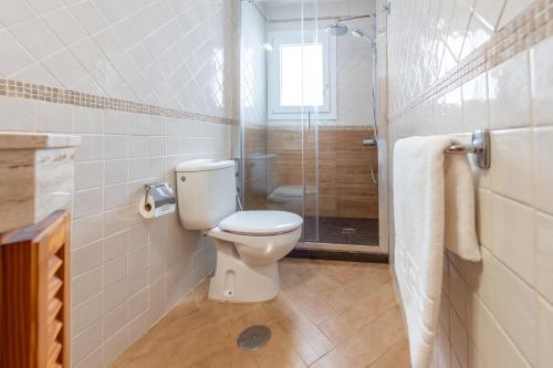 a bathroom with a toilet and a shower at Calas Beach Corralejo in Corralejo
