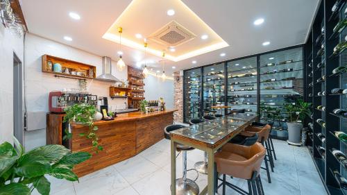a bar with a table and chairs in a restaurant at Yeosu View Foret Pension in Yeosu