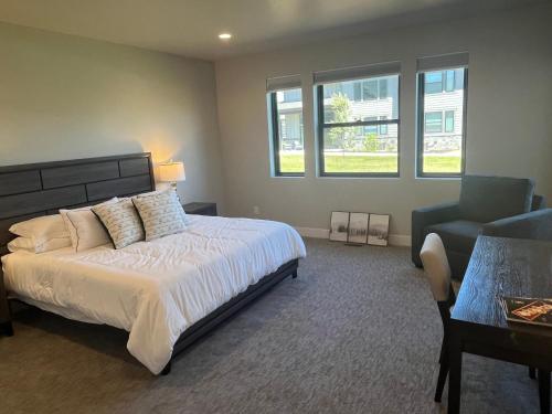 a bedroom with a bed and a couch and a chair at 4 bd Ski Villa with Hot Tub and Bunk Room by lake! in Heber City