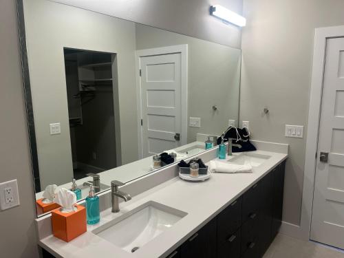 a bathroom with a sink and a large mirror at 4 bd Ski Villa with Hot Tub and Bunk Room by lake! in Heber City