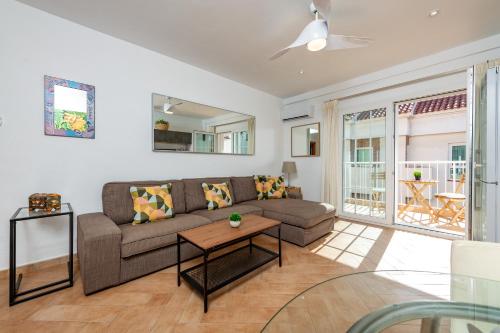 a living room with a couch and a table at Calas Beach Corralejo in Corralejo