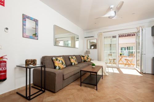 a living room with a couch and a table at Calas Beach Corralejo in Corralejo
