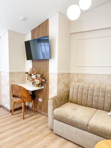 a living room with a couch and a table at Hotel Santa Elena Norte in Tunja