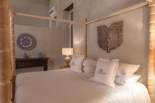 a bedroom with a white bed with white pillows at Hotel Casa Don Luis by Faranda Boutique, a member of Radisson Individuals in Cartagena de Indias