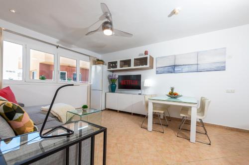 a living room with a couch and a table at Calas Beach Corralejo in Corralejo