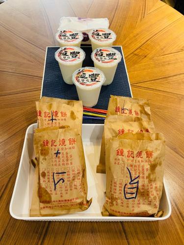 two plates of food on a table with cups of food at 萊恩晴旅包棟民宿 in Magong